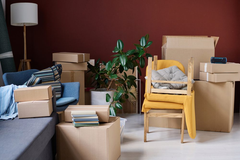 Room with packed boxes during move in new apartment